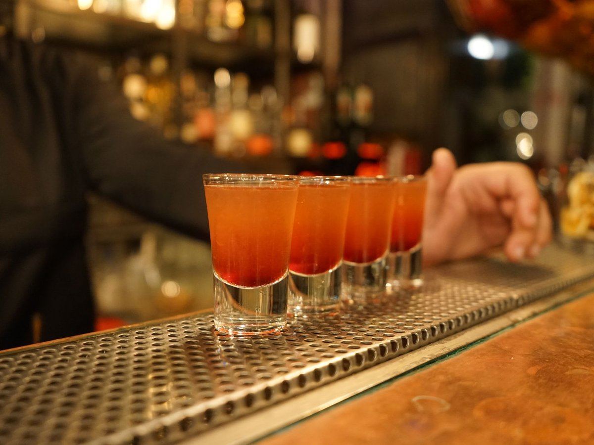Colorful cocktails lined up on a bar