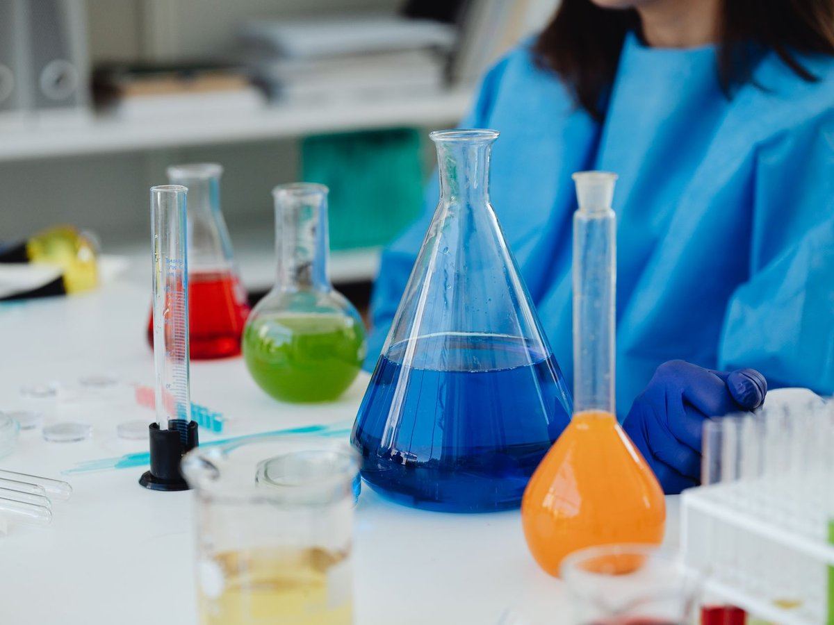 Laboratory flasks filled with colorful liquids